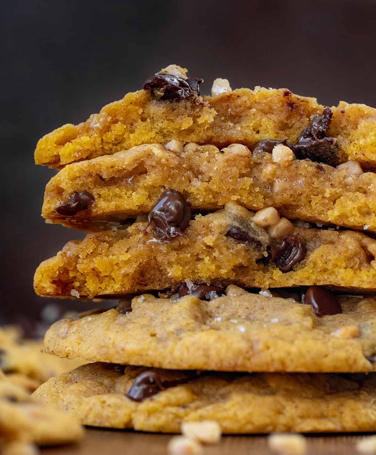 Close up of Pumpkin Toffee Chocolate Chip Cookies that are broken in half showing inside texture.