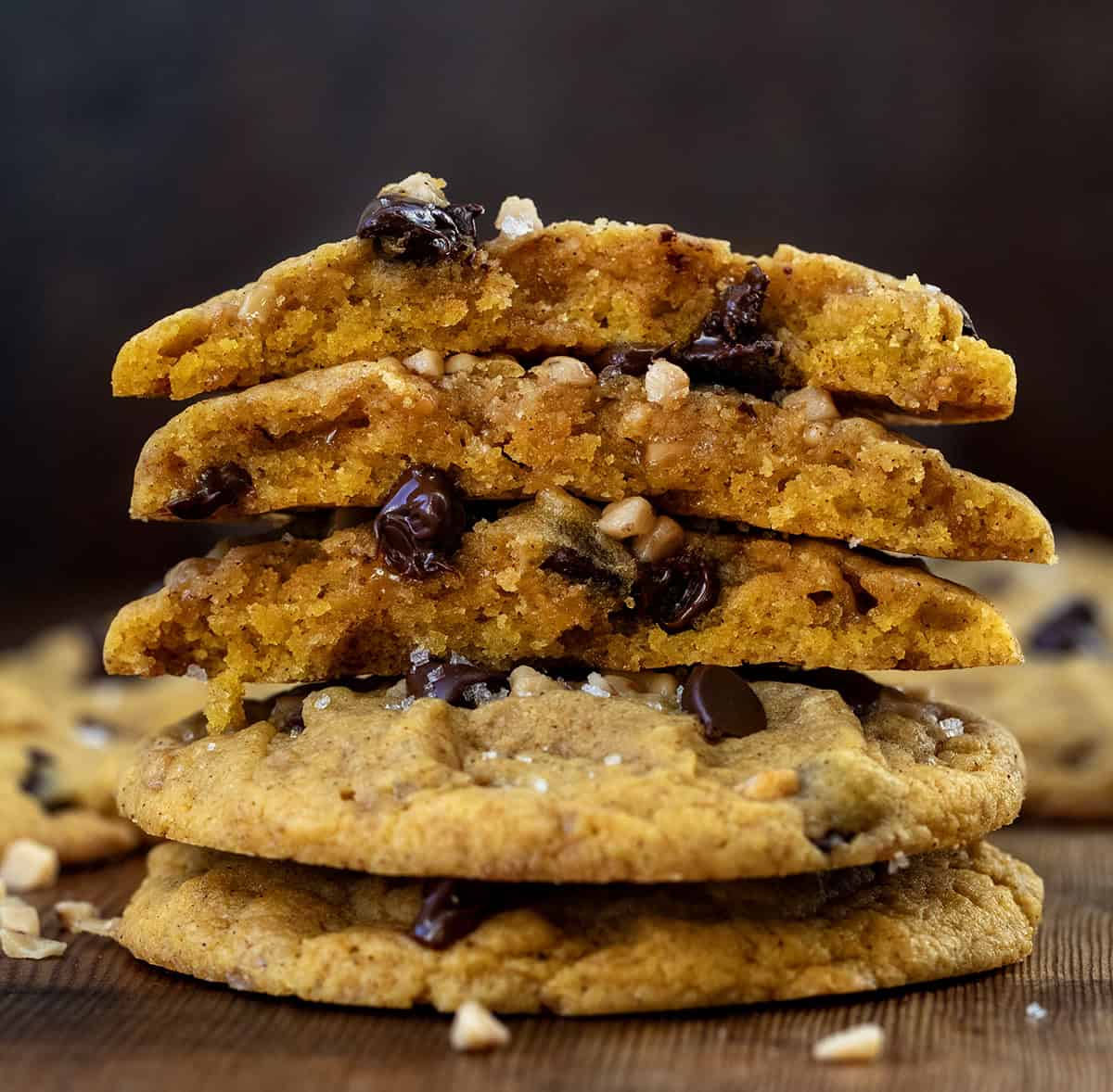 Small stack of broken in half Pumpkin Toffee Chocolate Chip Cookies.