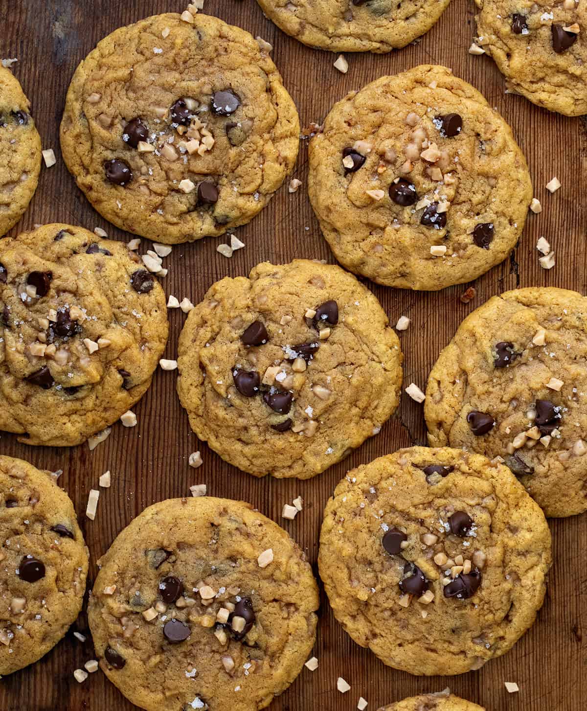 Pumpkin Toffee Chocolate Chip Cookies on a wooden table from overhead.