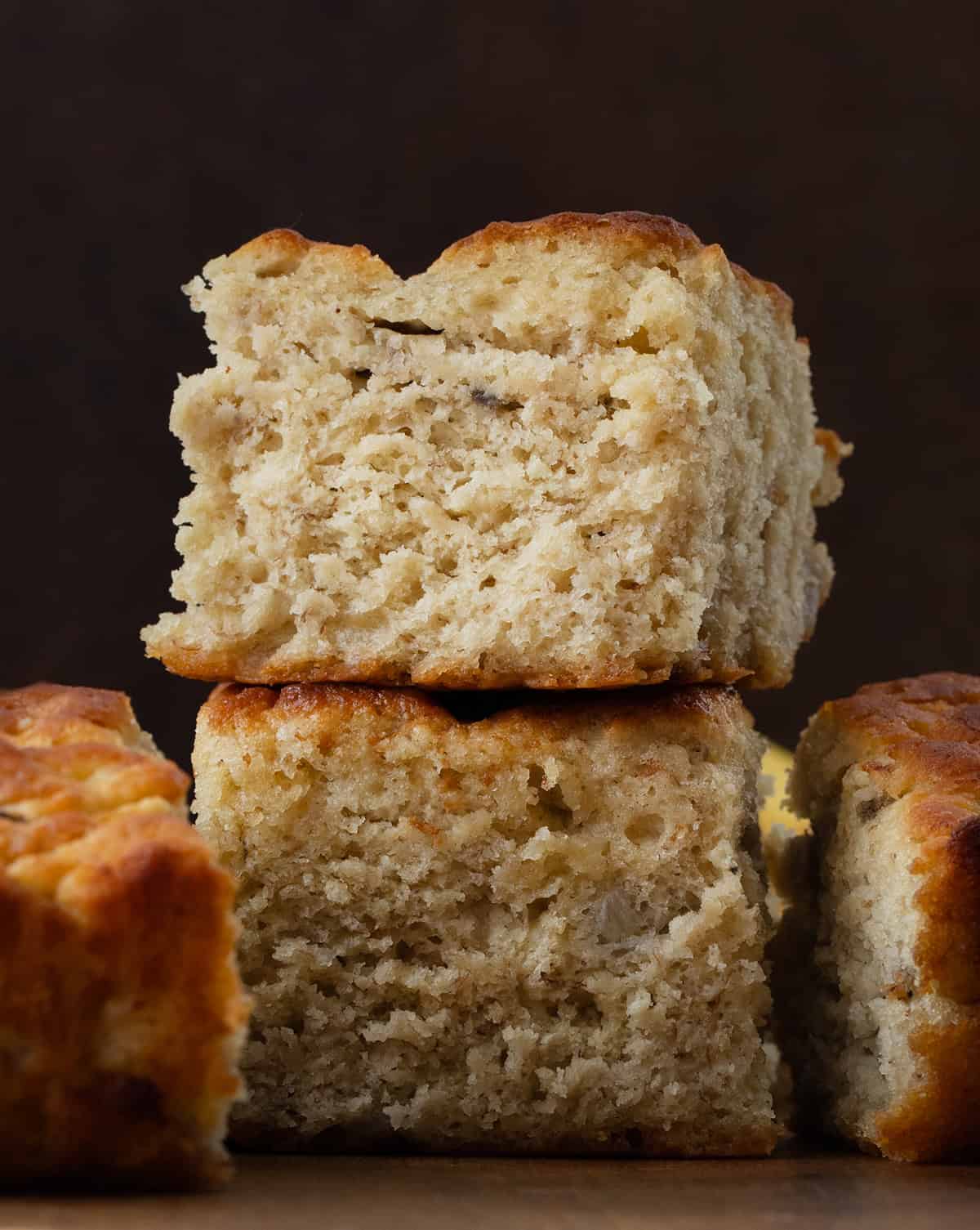 Small stack of Banana Butter Swim Biscuits on a wooden table very close up.