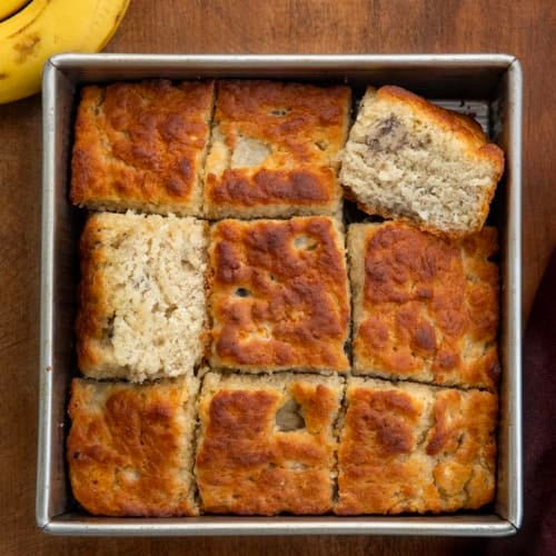Pan of Banana Butter Swim Biscuits cut up with a couple of biscuits on their side.