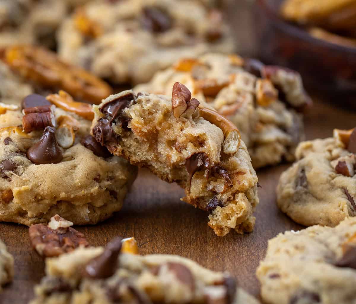 Halved Brown Sugar Cowboy Cookie showing inside texture surrounded by more cookies.