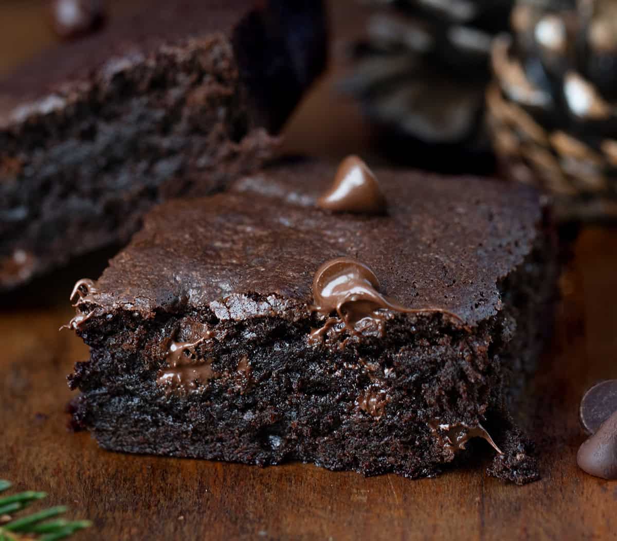 One Chocolate Gingerbread Brownie on a wooden table close up.