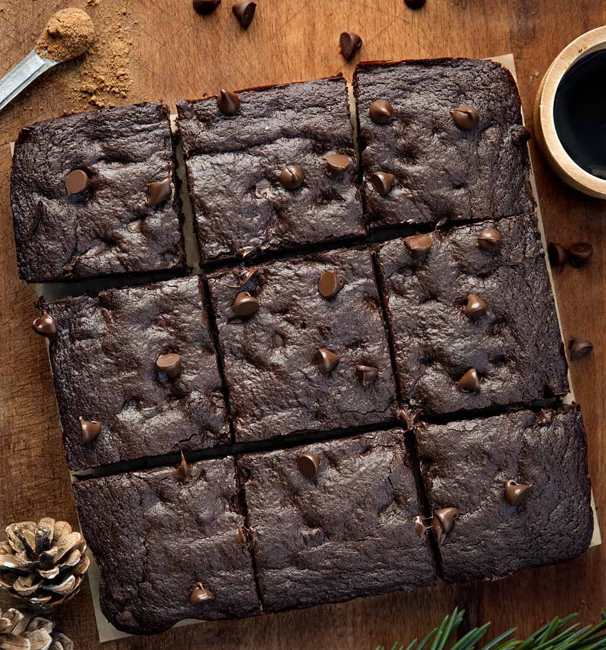 Chocolate Gingerbread Brownies cut into squares on a wooden table from overhead.