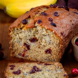 Cut into loaf of Cranberry Banana Bread with pieces laying flat.