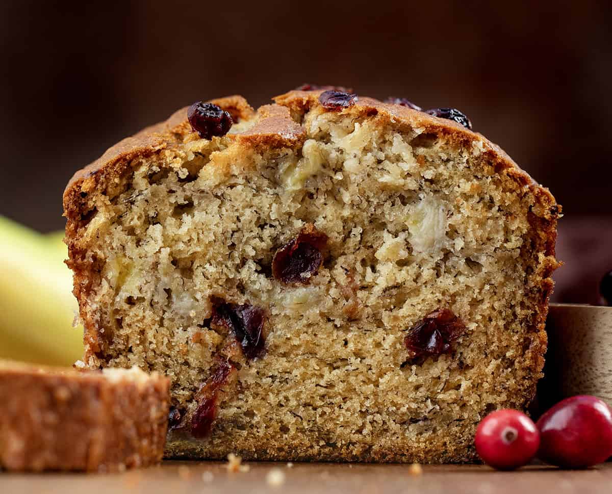 Loaf of Cranberry Banana Bread that has been cut into and is very close up.