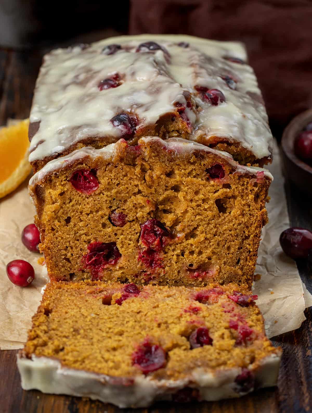 Slice of Cranberry Orange Pumpkin Bread with a few slices cut.