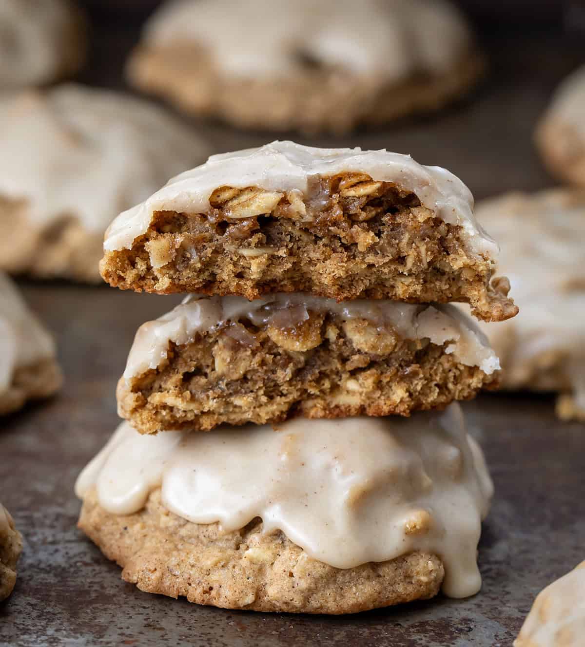 Small stack of Iced Gingerbread Oatmeal Cookies with the top cookie broken in half showing the inside texture Small stack of Iced Gingerbread Oatmeal Cookies with the top cookie broken in half showing the inside texture.