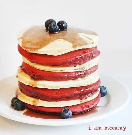 Stack of Red and white pancakes with blueberries on top. 