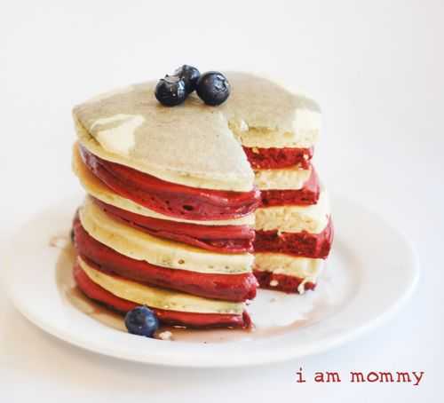 Stack of Red and white pancakes with blueberries on top. 