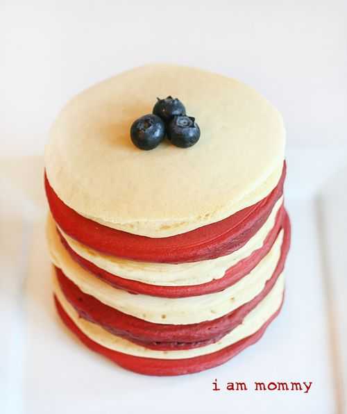 Stack of Red and white pancakes with blueberries on top. 