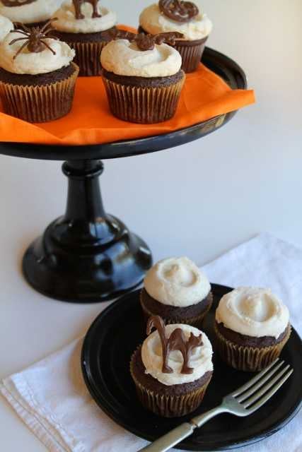 Plates of Pumpkin Buttercream Cupcakes with Chocolate Halloween Toppers